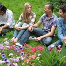 Students who are studying English at the Avalon English Language School in London relax in a park nearby.