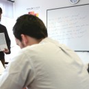 A teacher at Avalon School teaching English to a class of foreign students.