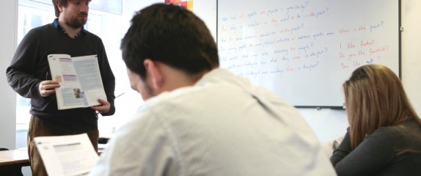 A teacher at Avalon School teaching English to a class of foreign students.